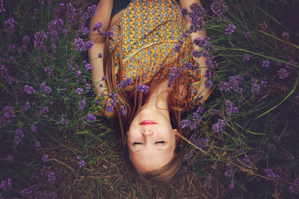 A woman lying peacefully in a lavender field, symbolizing healing and finding peace after going no contact with a narcissistic mother.