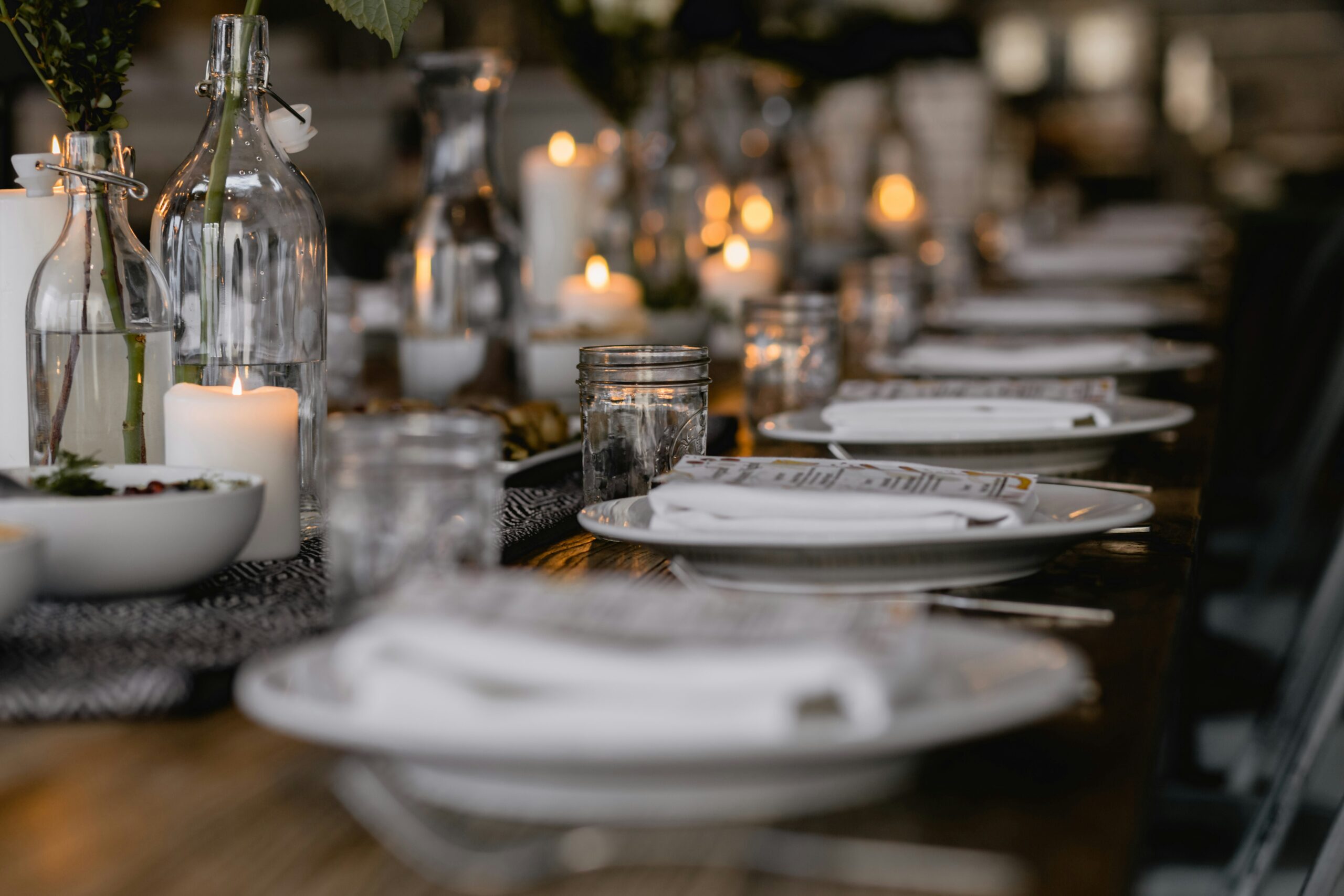 A serene holiday table stting with candels and floral decor, symbolizing the emtional balance and challenges of navigating the holidays with a narcissistic mother.