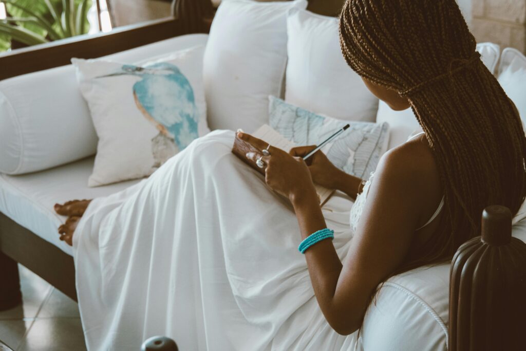 A woman journaling in a peaceful setting, symbolizing the emotional preparation for how to go no contact with your narcissistic mother.